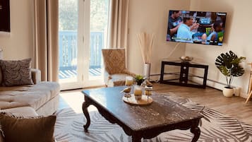Deluxe Apartment | Living area | 55-inch Smart TV with digital channels, TV, Netflix