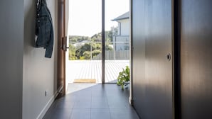 A modern interior with a sliding glass door leading to an outdoor deck.