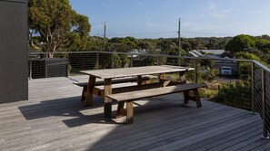 A wooden deck with a picnic table and metal railing overlooking a residential area with houses and trees. - Stage 1 - Point Lonsdale (Point Lonsdale)