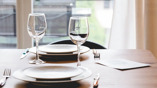 A dining table set with two wine glasses, plates, cutlery, and a napkin. - The Parc des Raisses - T2 for 4 people (Annecy)