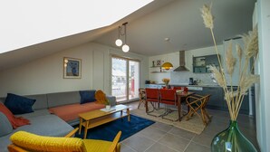 A modern loft apartment with a living area, dining space, and kitchen. - The Azalea, beautiful quiet apartment for 4 people! (Doussard)