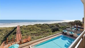 A pool with a view of the beach and ocean. - Beacher's Oceanfront Balcony Suite with Onsite Front desk and staff (St. Augustine)