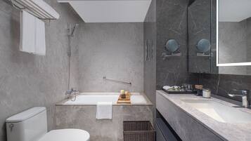 Une salle de bain moderne équipée de toilettes, d’une baignoire et d’un lavabo.