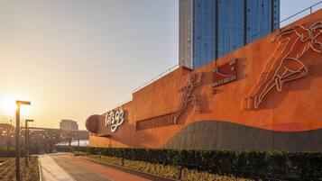 A modern building with a large sign reading "Let’s Go" and a mural of a running figure.