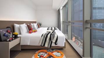 Enjoy a city view from the comfort of a spacious bed with a large window.