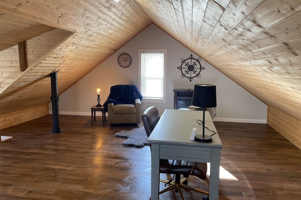 Bonus space with work desk, electric fireplace, cozy corner