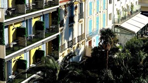 A multi-story building with balconies, a red-tiled roof, and a sign reading "HOTEL DE PROVENCE". - Viva Riviera Large 1 Bedroom with Sunny Terrace (Cannes)