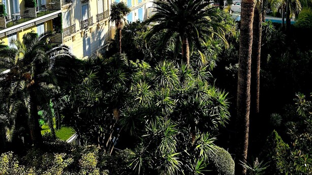 A multi-story building with balconies, a red-tiled roof, and a sign reading "HOTEL DE PROVENCE". - Viva Riviera Large 1 Bedroom with Sunny Terrace (Cannes)