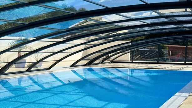 A swimming pool with a glass ceiling structure. - Spacious 3-room apartment, summer pool (Jaroslawiec)
