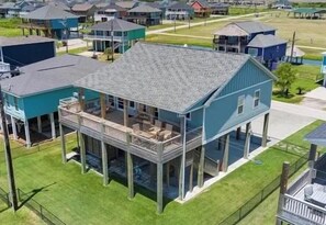 A two-story house with a balcony, a covered porch, and a garage.