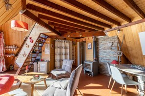 Cozy chalet with a warm interior, comfortable seating, and a fireplace, perfect for relaxation and socializing.