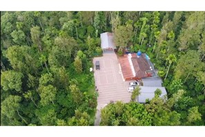 Set amidst lush greenery, this property offers a tranquil retreat with easy parking and a simple, functional design.
