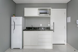 Fridge, microwave, coffee/tea maker, cookware/dishes/utensils