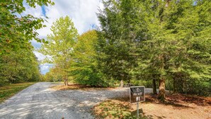 A gravel road leading to an RV site with a sign indicating it is site #1. - RV Site 4 of 4: Lot rental only; RVs not provided. (South Bloomingville)