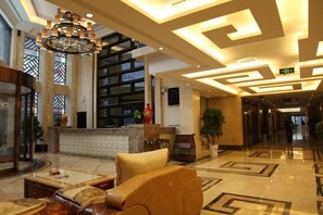 A spacious lobby with a reception desk, seating area, and a large chandelier. - Lingyue Hotel (Changyang)