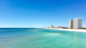 A coastal hotel with a beach view, multiple buildings, and a clear blue sky. - Pearl 1003 Sugar white sand and emerald waters (Navarre)