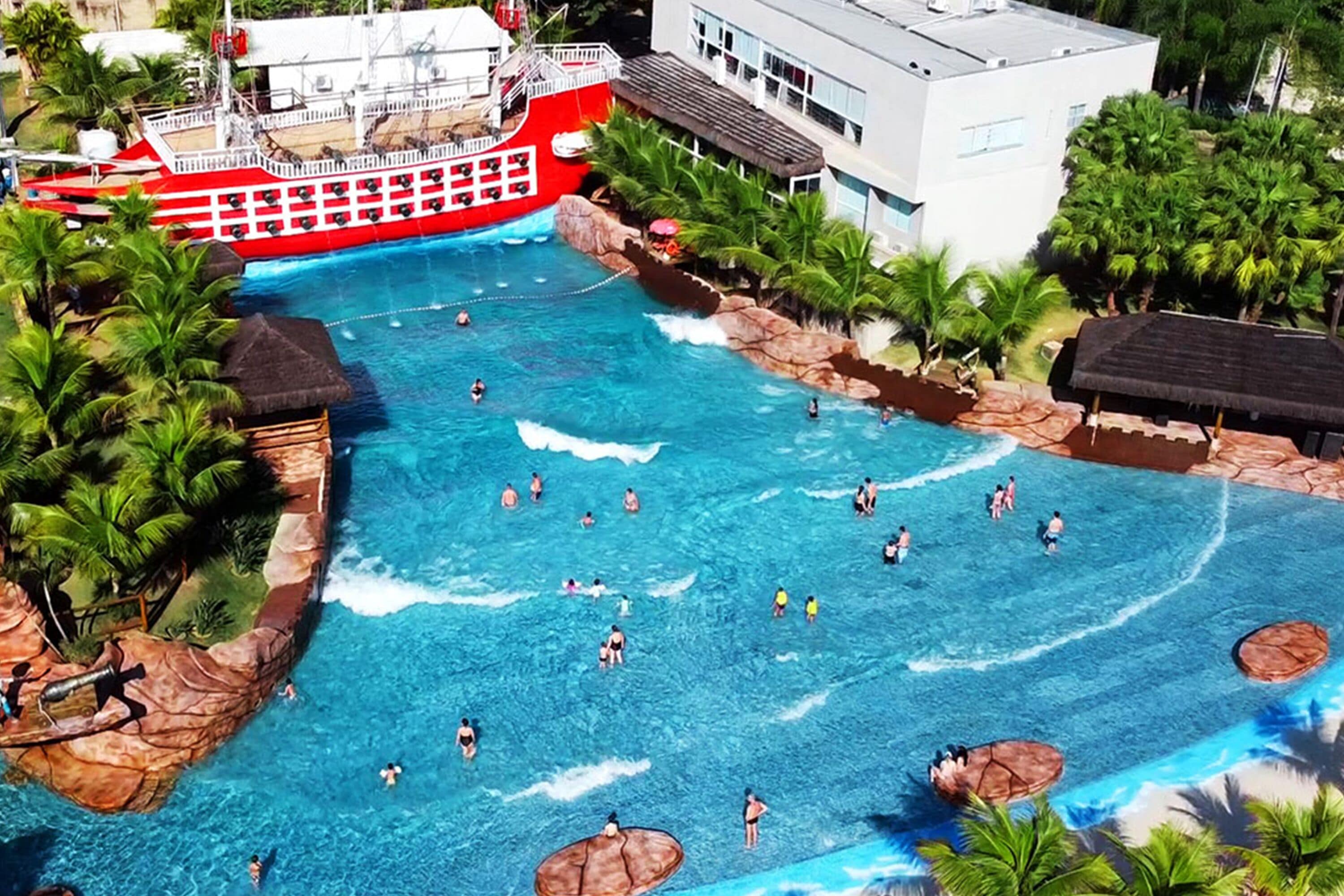 A large outdoor pool with multiple levels and a boat-shaped structure.