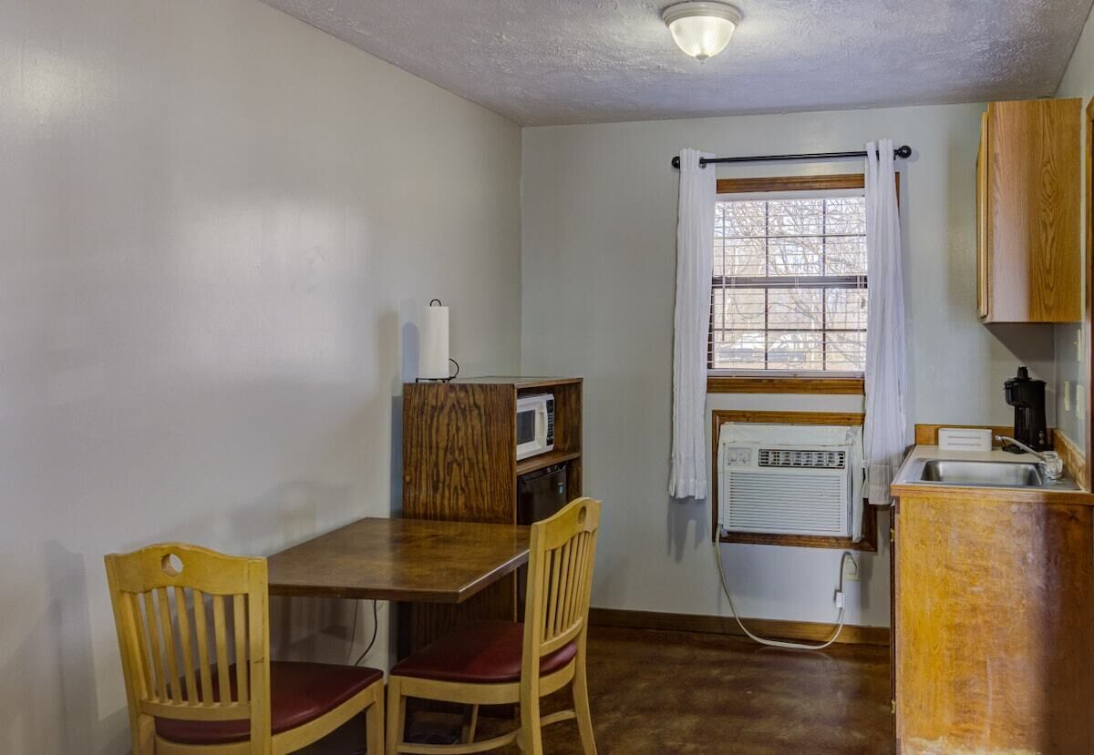 Coffee/tea maker, microwave, cookware/dishes/utensils, dining table