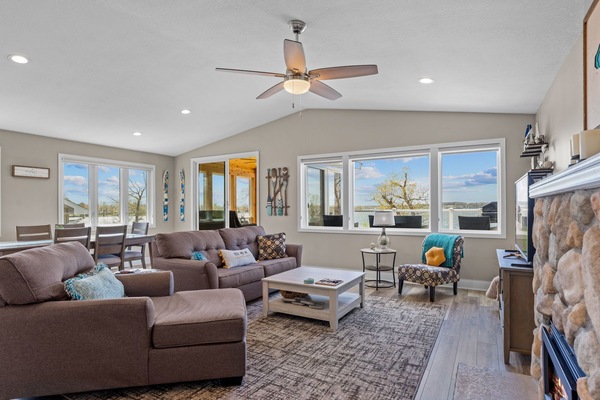 Open concept living room with sleeper sofa, smart TV and gas fireplace