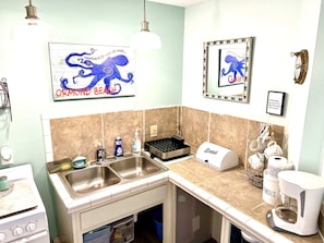 Enjoy cooking in this well-equipped kitchen with a double sink, stainless steel range hood, and oven.