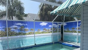 Piscina con vistas a palmeras y un cielo despejado.