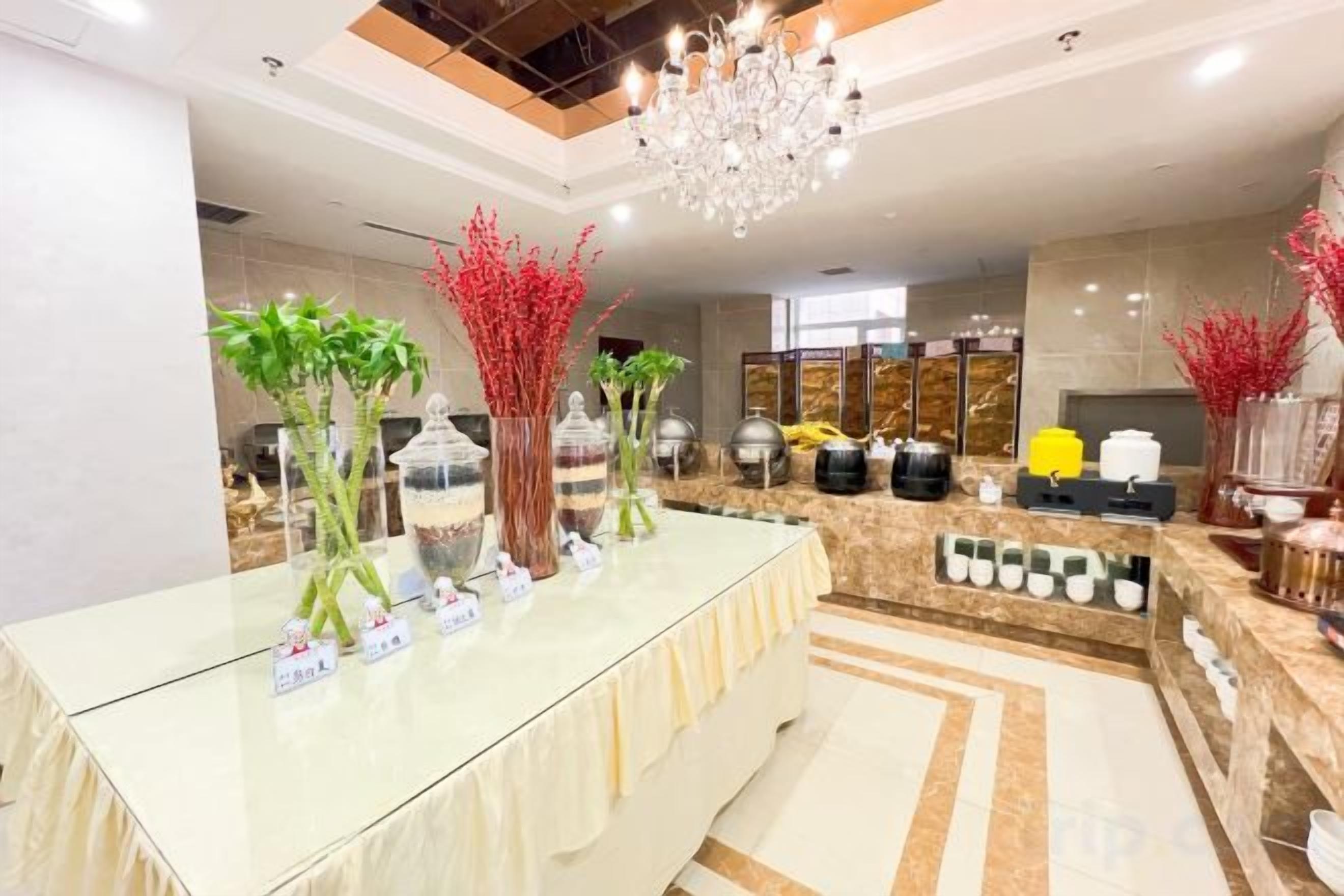 A reception area with a glass counter, decorative plants, and a chandelier.