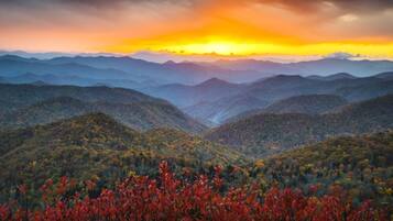 A mountainous landscape with a sunset.