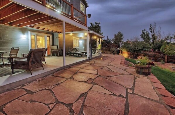 Enjoy a relaxing stay in this two-story home with a covered patio and balcony overlooking a beautifully maintained garden.