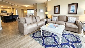 A modern living room with two sofas, a coffee table, and a patterned rug. - Amazing Villa w/ Beautiful Views from Balcony! (Hilton Head Island)