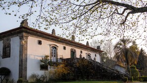 A historic building with a symmetrical facade, arched windows, and a central entrance. - Casa de Juste (Lousada)