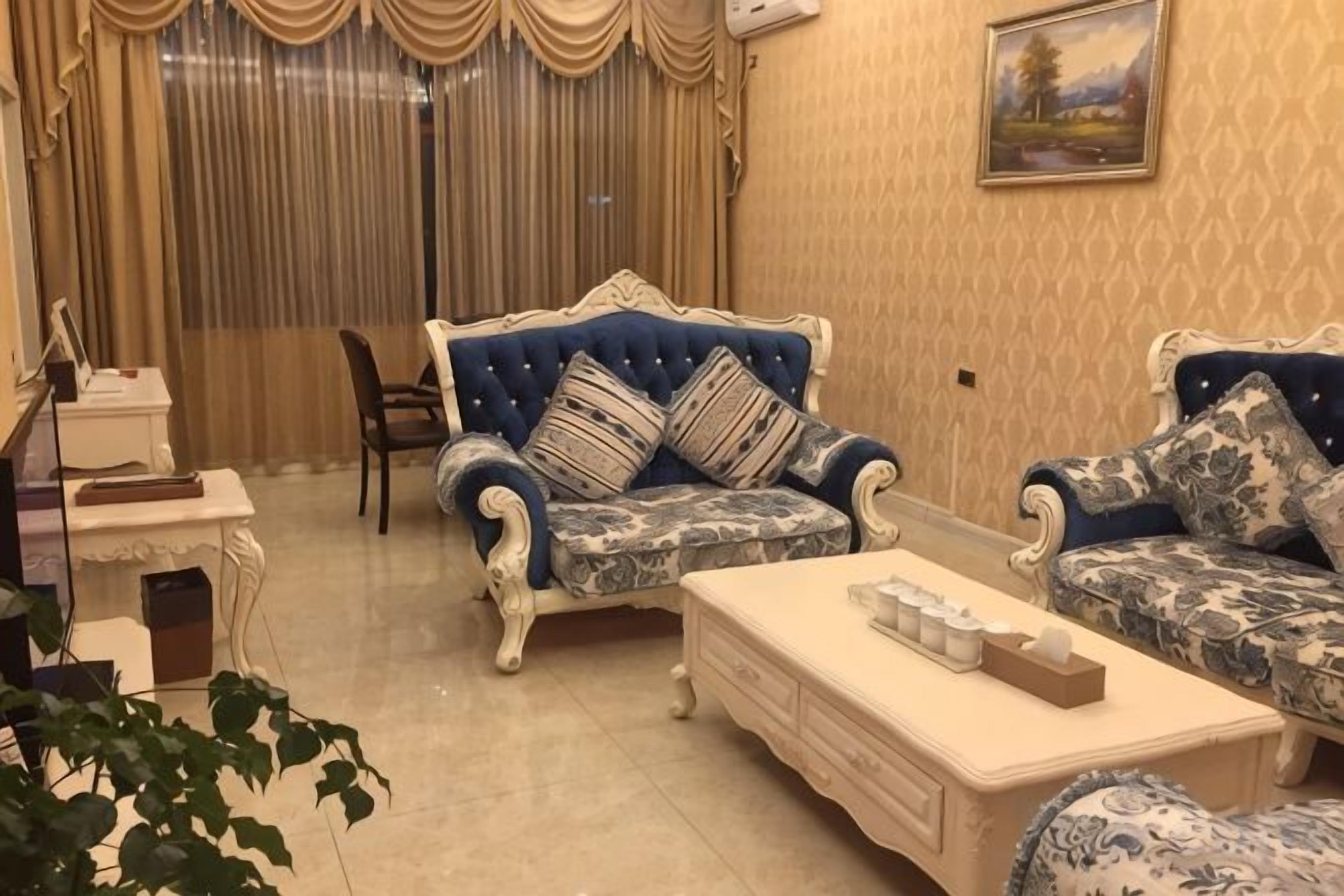 A living room with two patterned sofas, a coffee table, and a chair.