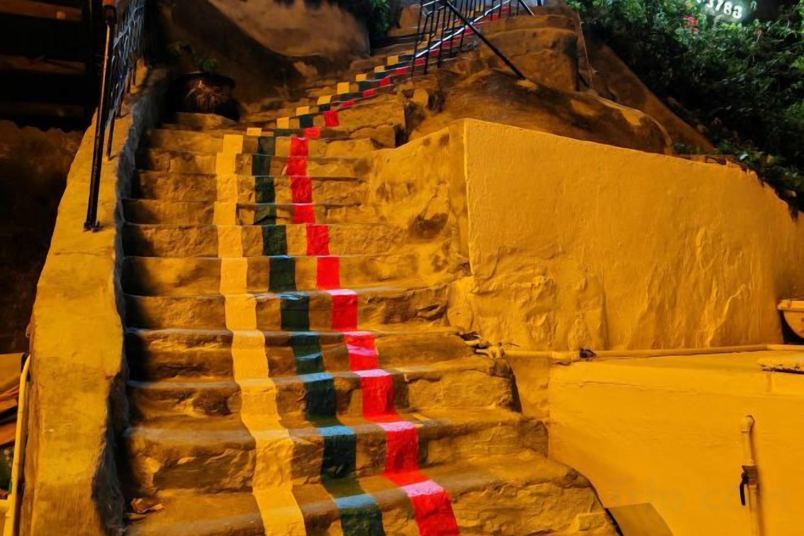 A staircase with steps painted in alternating colors.