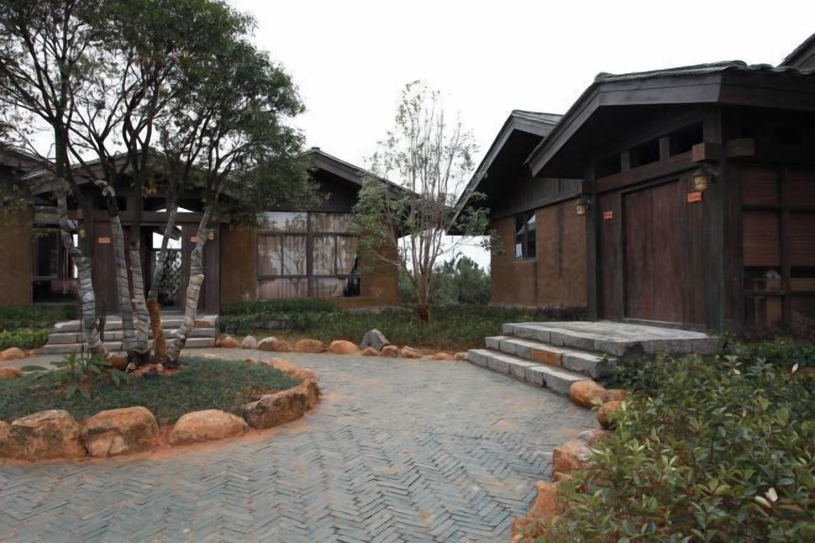 A traditional wooden building with a stone pathway leading to the entrance.