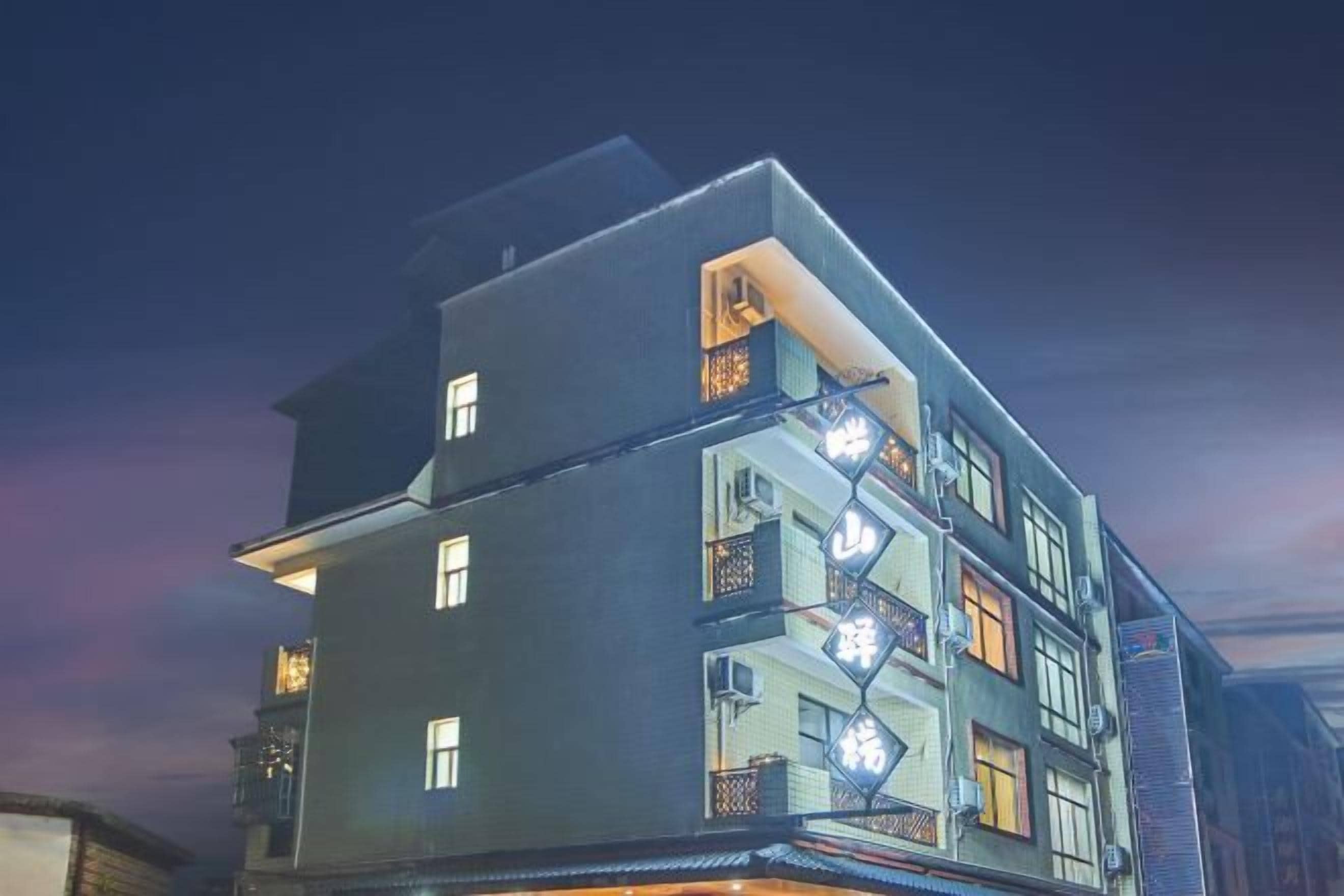 A multi-story building with balconies and a modern architectural design.