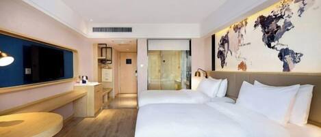 A hotel room with a large bed, a desk, a chair, and a television.