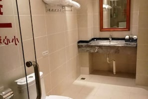 Une salle de bain avec un lavabo, un miroir et des toilettes.