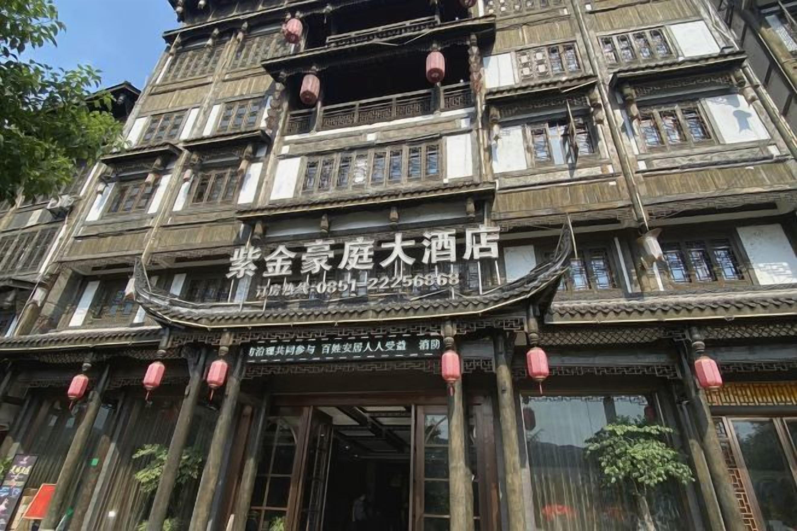 A traditional multi-story building with a sign indicating it is a hotel.