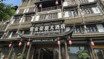 A traditional multi-story building with a sign indicating it is a hotel.