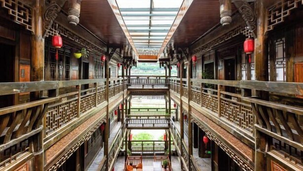 A traditional multi-level wooden building with balconies and a central open space. - Zijin Haoting Hotel (Renhuai)