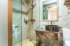 A bathroom with a glass shower enclosure, a marble sink, and a mirror above the sink. - Zijin Haoting Hotel (Renhuai)