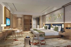 A modern hotel room with a bed, bedside tables, a desk, a chair, a TV, and a decorative wall. - Ya Le Xuan Hotel (Shehong)