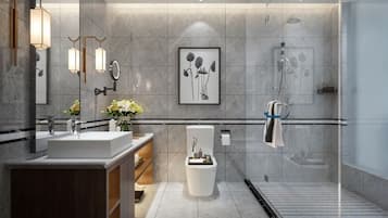 A modern bathroom with a large mirror, two sinks, a toilet, and a shower area.