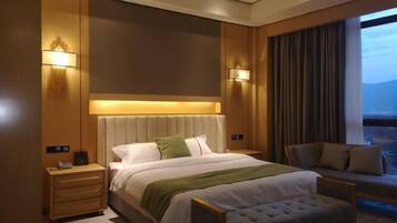 A hotel room with a large bed, bedside tables, a chair, and a view of the outdoors.