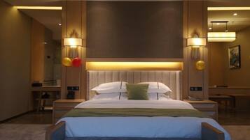 A modern hotel room with a large bed, bedside tables, a bench, and ambient lighting.