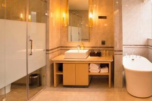 A modern bathroom with a glass shower enclosure, a wooden vanity with a sink, and a standalone bathtub. - Ya Le Xuan Hotel (Shehong)