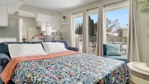 A bedroom with a bed, a desk, and a view of the outdoors. - PROMO 10% WEEKLY AND 15% MONTHLY OFF
Naperville/Aurora, King Bed, Fenced Yard! (Aurora)