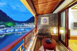 Enjoy breathtaking views of the water and mountains from this balcony.