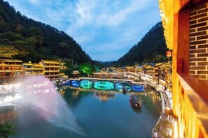 Explore the serene beauty of a traditional Chinese water town, where historic bridges and buildings meet the tranquil river.