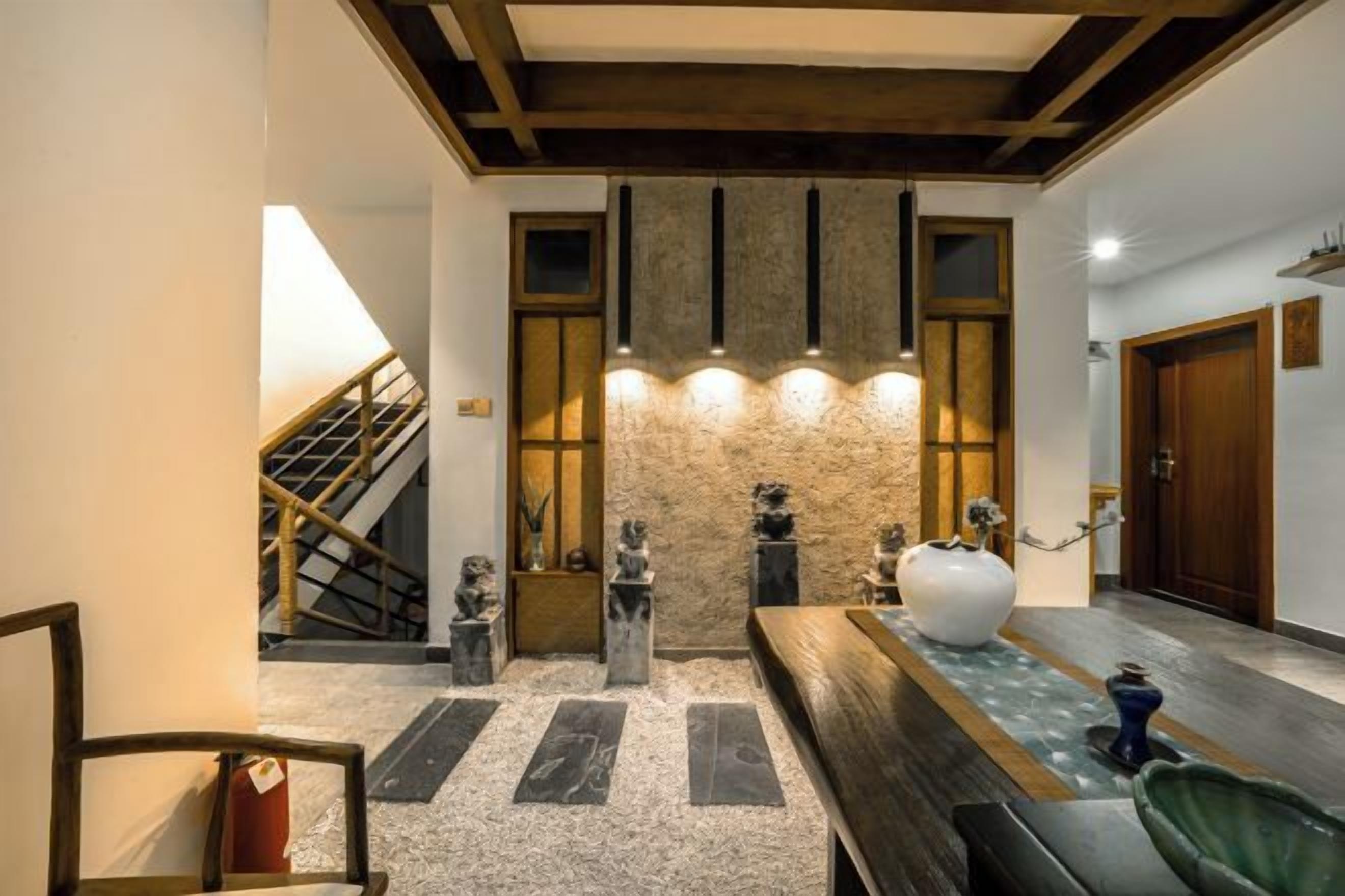 A reception area with a stone wall, wooden ceiling, and a reception desk.