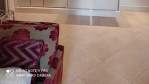 A compact kitchen with a microwave, coffee maker, and a red cabinet. - Deluxe flat 2 bedrooms (Roma)